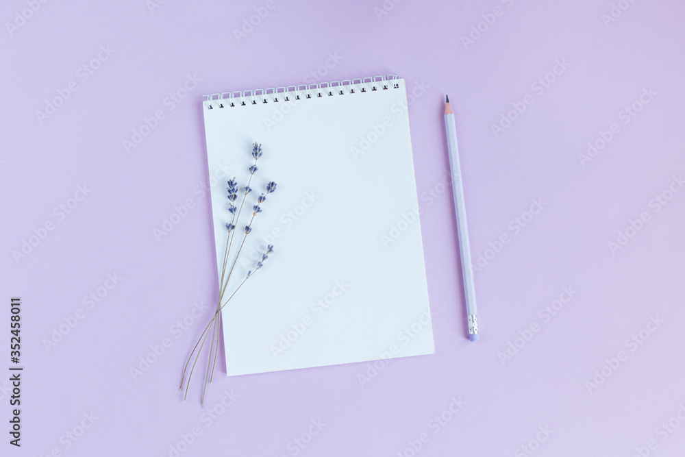 Notebook with blank page, pencil and lavander on a violet background. Notebook with blank page, pencil and lavander on a violet background.