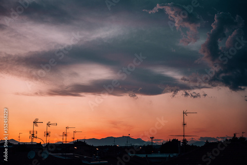 Warm sunset with clouds and silhouette