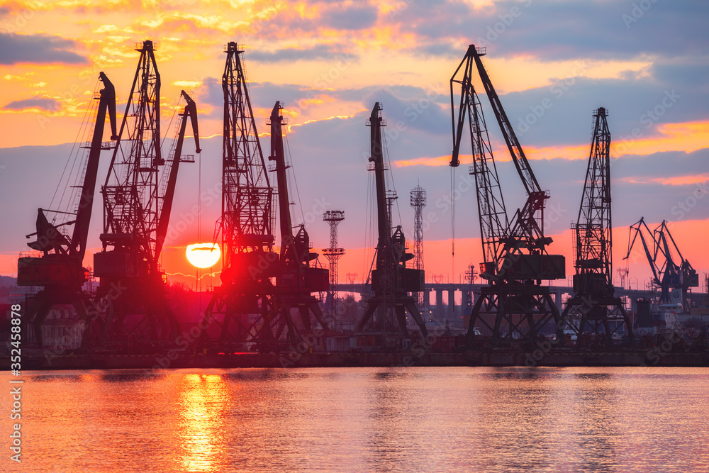 Sea port and industrial cranes, Varna, Bulgaria.Sunset over the Varna lake