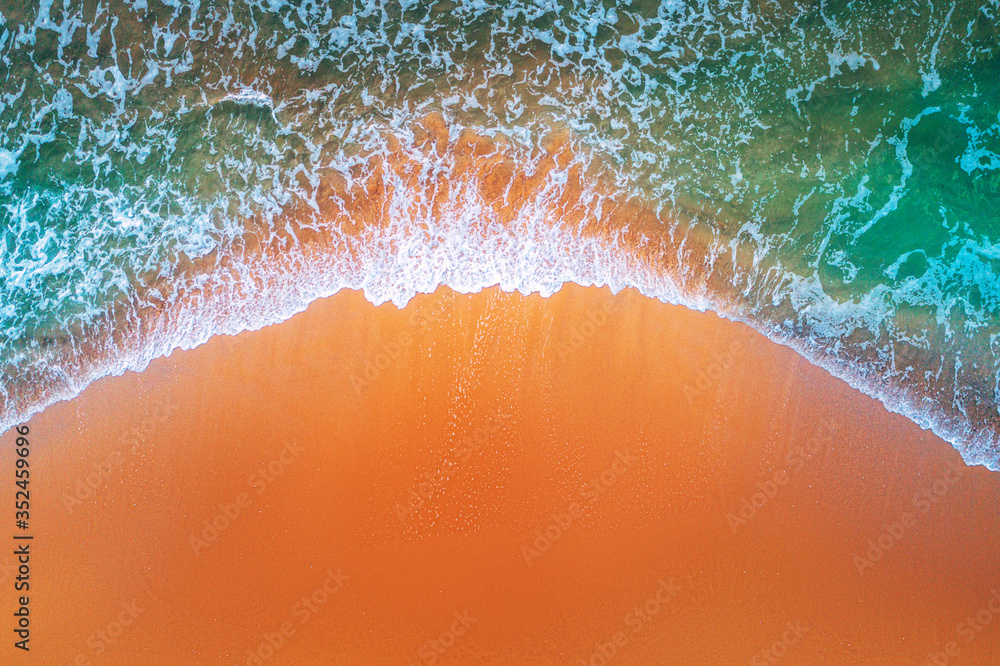 Aerial view of sea waves and sandy beach