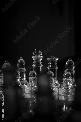 glass pieces of chess on a chessboard