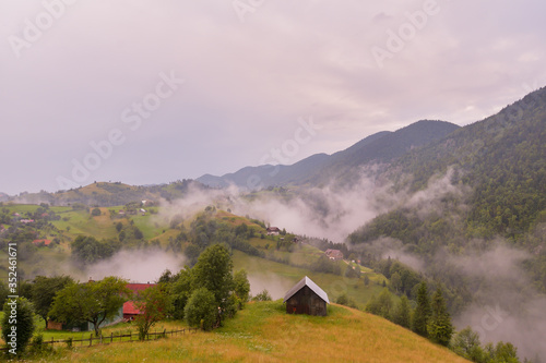 Stunning nature with misty landscape Holbav village Carpathians Transylvania Romania Europe