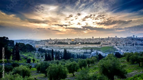 Beautiful sunset clouds over the Old City Jerusalem with Dome of the Rock, the Golden/Mercy Gate and St. Stephen's/Lions Gate; view from the Mount of Olives with olive trees in the foreground photo