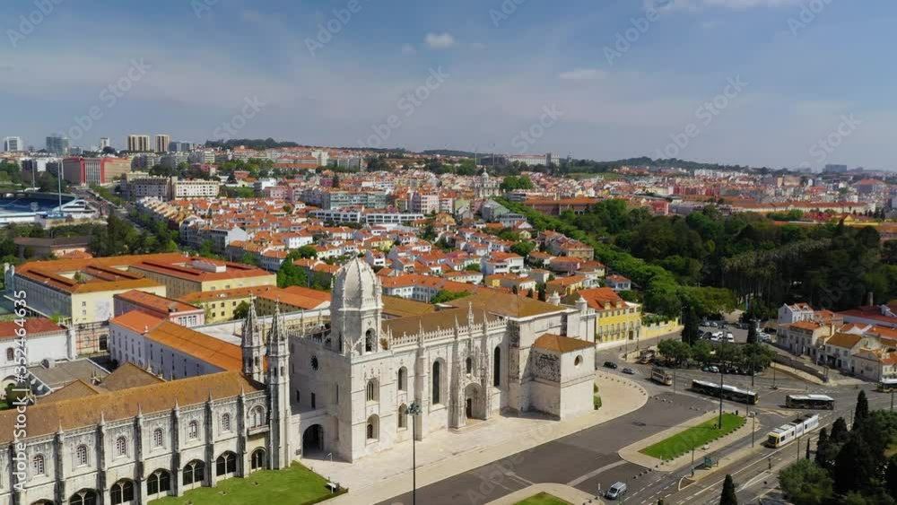 Aerial view of the empty Jeronimos Monastery and homes in Santa Maria de Belem, sunny day, Lisbon, Portugal - pan, drone shot Aerial view of the empty Jeronimos Monastery and homes in Santa Maria de Belem, sunny day, Lisbon, Portugal - pan, drone shot