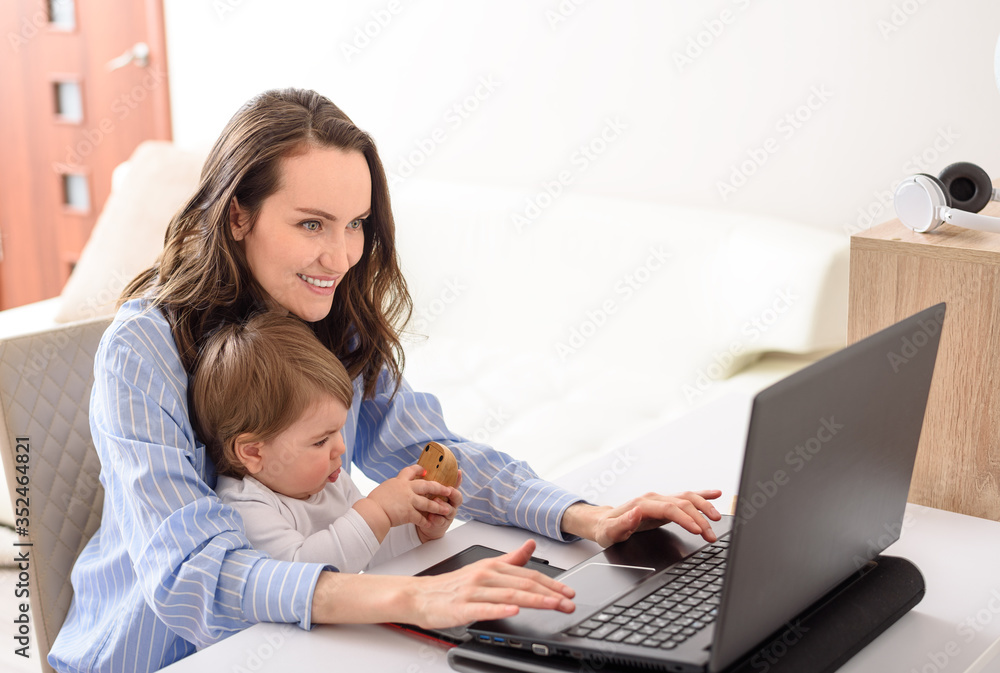 mother and daughter sitting at laptop, remote work at home, motherhood, maternity leave, online learning mother and daughter sitting at laptop, remote work at home, motherhood, maternity leave, online learning