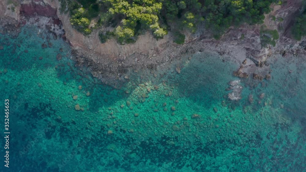 Aerial drone shot of a rocky shoreline with crystal clear water in Spain Aerial drone shot of a rocky shoreline with crystal clear water in Spain
