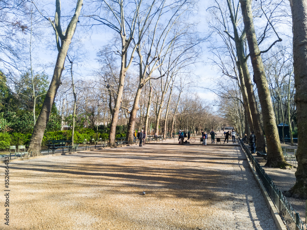 Luxembourg gardens, Paris, France. Beautiful sand path during the winter season. No leaves in the tree and fewer tourists.