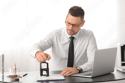 Male lawyer working with do...