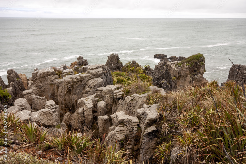 The stunning rocks of Punakaiki, Pancake rocks blowholes, are a tourist attraction. South Island of New Zealand The stunning rocks of Punakaiki, Pancake rocks blowholes, are a tourist attraction. South Island of New Zealand