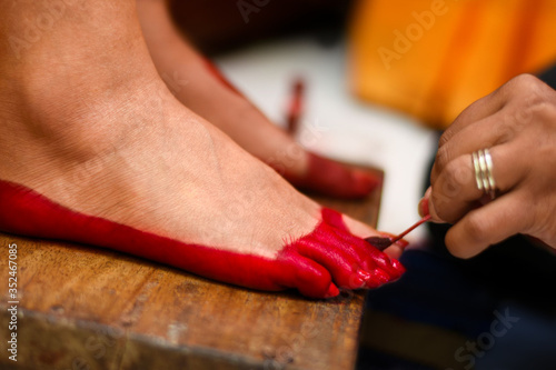 Alta design on feet of girl for hindu Indian wedding ceremony