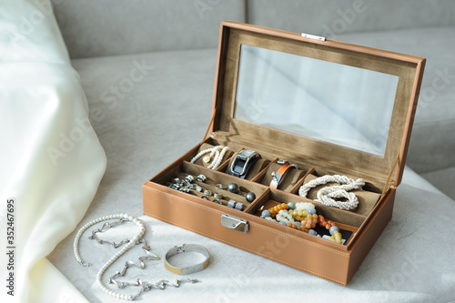 Obraz na plátně Leather jewelry box with jewelry and accessories laid on a couch