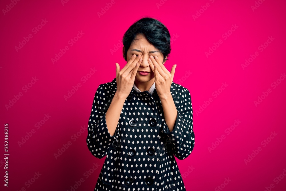 Young beautiful asian girl wearing casual jacket standing over isolated pink background rubbing eyes for fatigue and headache, sleepy and tired expression. Vision problem Young beautiful asian girl wearing casual jacket standing over isolated pink background rubbing eyes for fatigue and headache, sleepy and tired expression. Vision problem