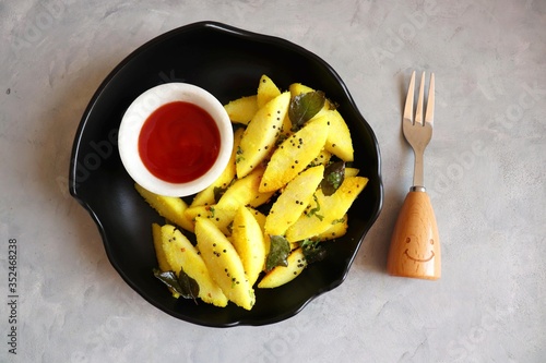 Tea time food - Masala idli or tadka fried idly is a very tasty dish made out of leftover idlis. best to eat as breakfast or snacks.  served with tomato ketchup. copy space. photo