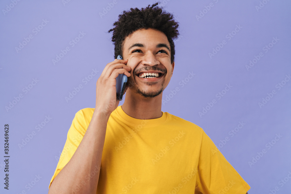 Photo of african american man talking on smartphone and laughing Photo of african american man talking on smartphone and laughing