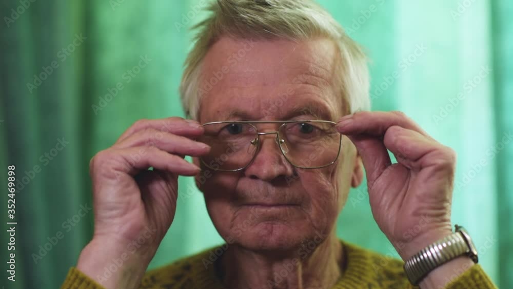 Portrait of a senior man taking off his glasses and looking at the camera Portrait of a senior man taking off his glasses and looking at the camera