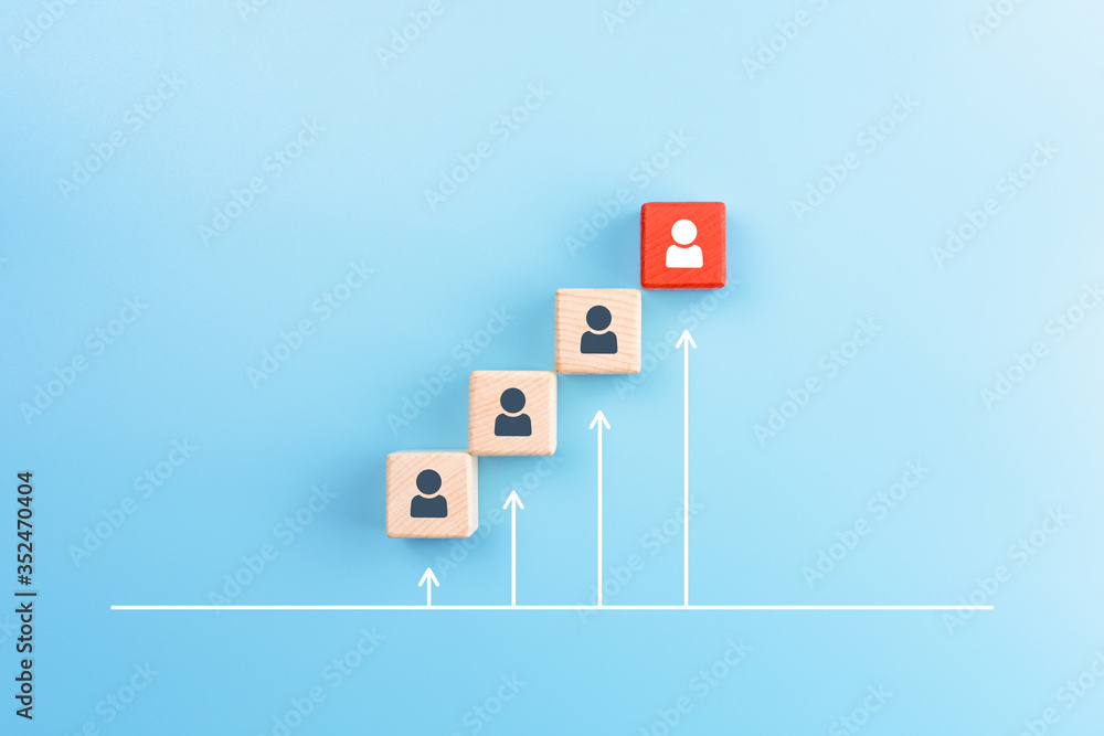 Personal development and Career growth concept, Wooden cubes stacking as step stair with person icons and white arrow up on blue background Personal development and Career growth concept, Wooden cubes stacking as step stair with person icons and white arrow up on blue background