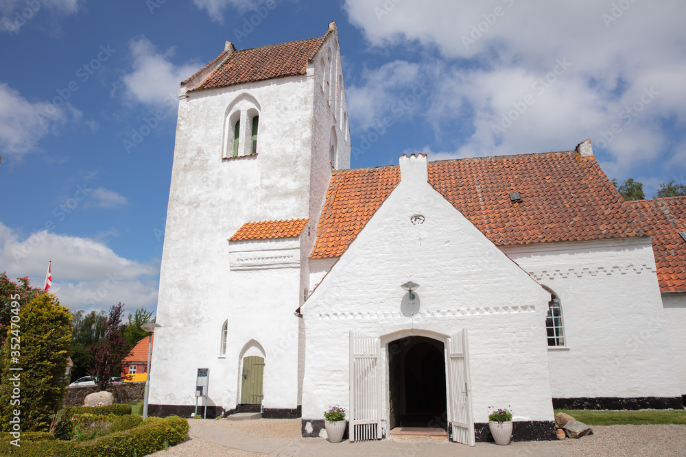 old danish church with blue sky and clouds