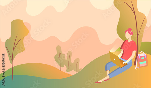 A girl sits under a tree in a park and works on a laptop. Background landscape of hill trees and orange sky