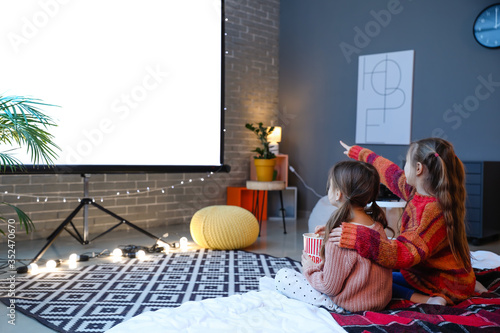 Little girls watching movie...