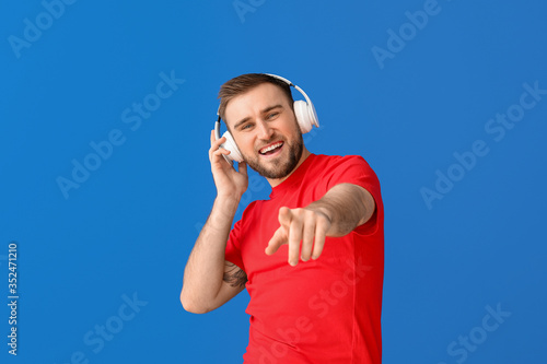 Handsome young man listenin...