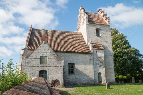 old danish church on stevns in denmark almost falling into the ocean photo