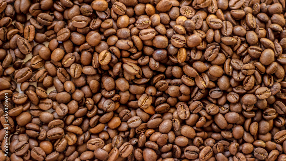 Fresh coffee beans brown seed texture background full wallpaper. Coffee beans roasted for the background. Mixture of different kinds of coffee beans. Close up. Fresh coffee beans brown seed texture background full wallpaper. Coffee beans roasted for the background. Mixture of different kinds of coffee beans. Close up.