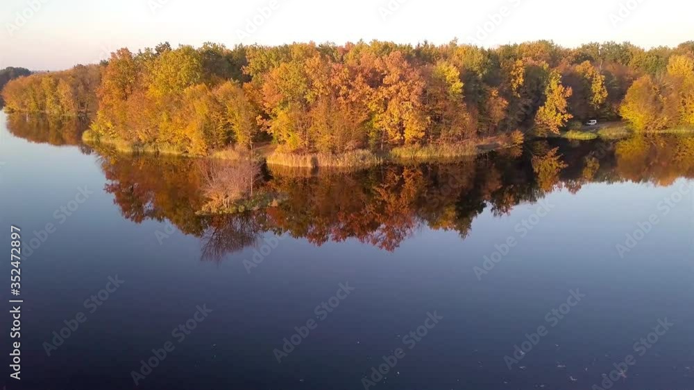 Aerial view of the Island on Teterev River autumn with trees on which yellow foliage Aerial view of the Island on Teterev River autumn with trees on which yellow foliage