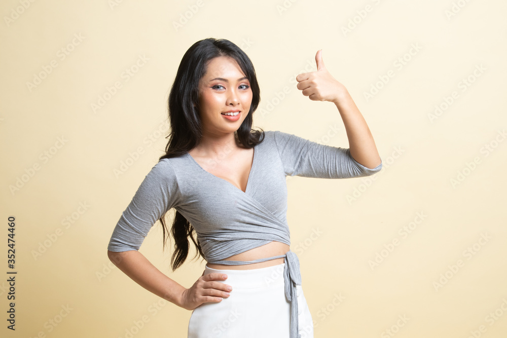 Young Asian woman show thumbs up. Young Asian woman show thumbs up.