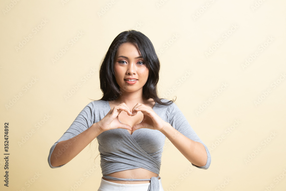 Young Asian woman show heart hand sign. Young Asian woman show heart hand sign.
