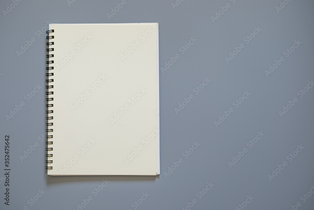 Top view of white school notebook on a gray background with copy space Top view of white school notebook on a gray background with copy space
