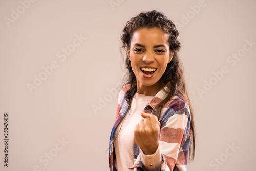 Studio shot portrait of beautiful happy african-american ethnicity woman in casual clothing.
