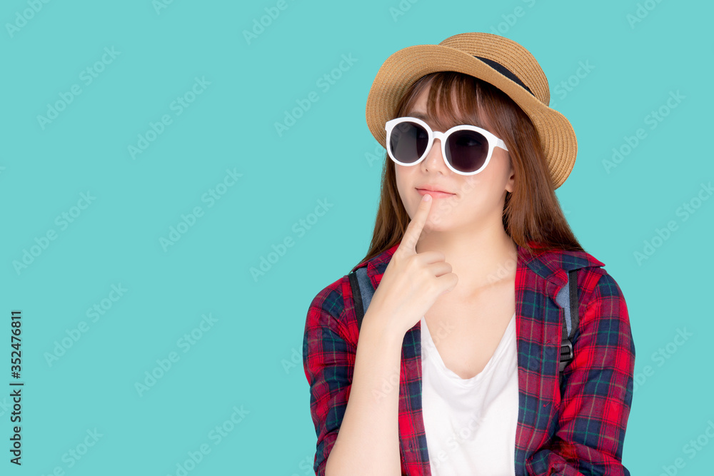 Beautiful portrait young asian woman wear sunglasses and hat having backpack smile confident enjoy summer holiday isolated blue background, tourist model girl thinking idea planning travel concept. Beautiful portrait young asian woman wear sunglasses and hat having backpack smile confident enjoy summer holiday isolated blue background, tourist model girl thinking idea planning travel concept.