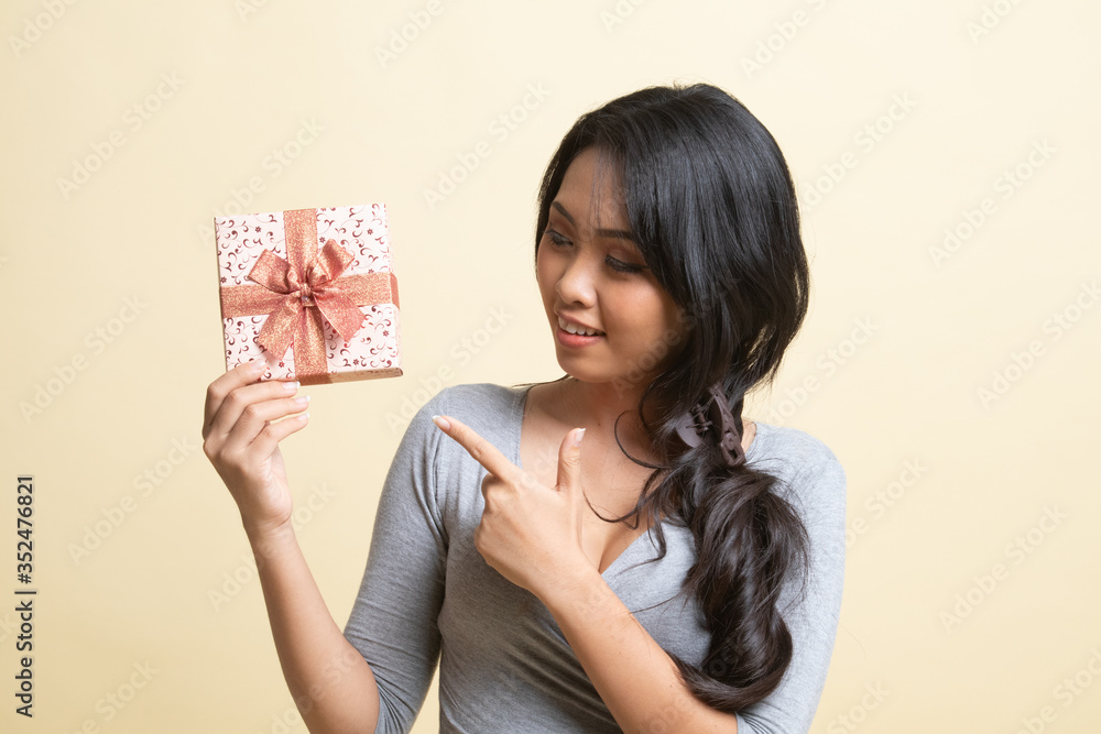 Young Asian woman with a gift box. Young Asian woman with a gift box.