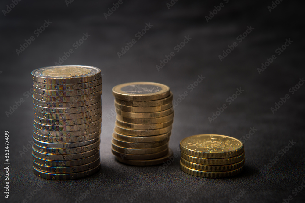 detail of three stacked euro coins front view on a black background detail of three stacked euro coins front view on a black background