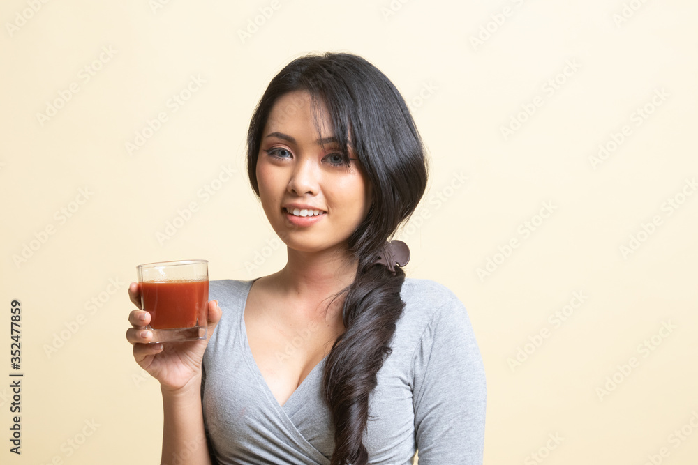 Young Asian woman drink tomato juice. Young Asian woman drink tomato juice.