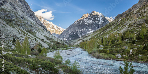 river between mountains in ecrins mountain range, french alps
