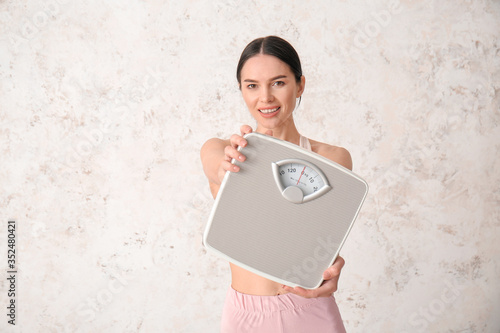 Young woman with measuring ...