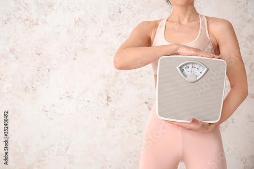 Young woman with measuring ...