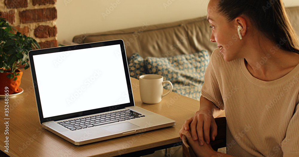 Fototapeta premium Woman shows a smartphone with a green screen. Person has reached out a hand and is showing a blank screen mockup