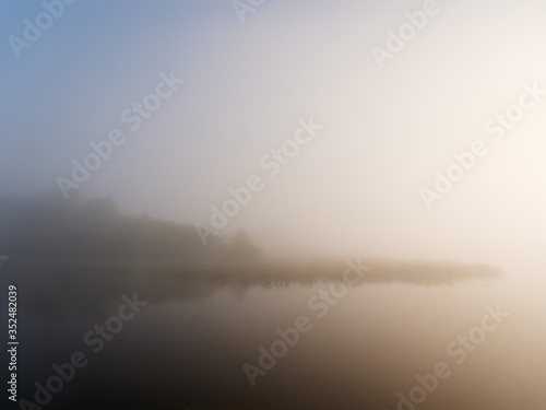 foggy morning on the river near the floodplain meadow