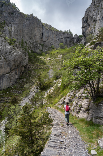 Female hiker on mountain pathway, Ligurian Alps, Italy