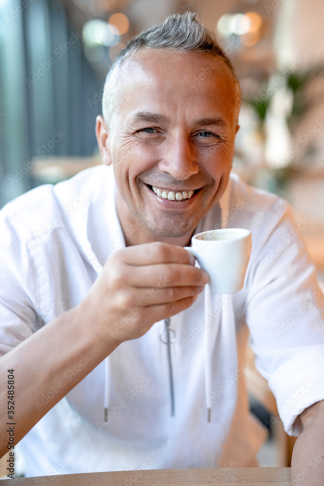 man drinking coffee in cafe man drinking coffee in cafe