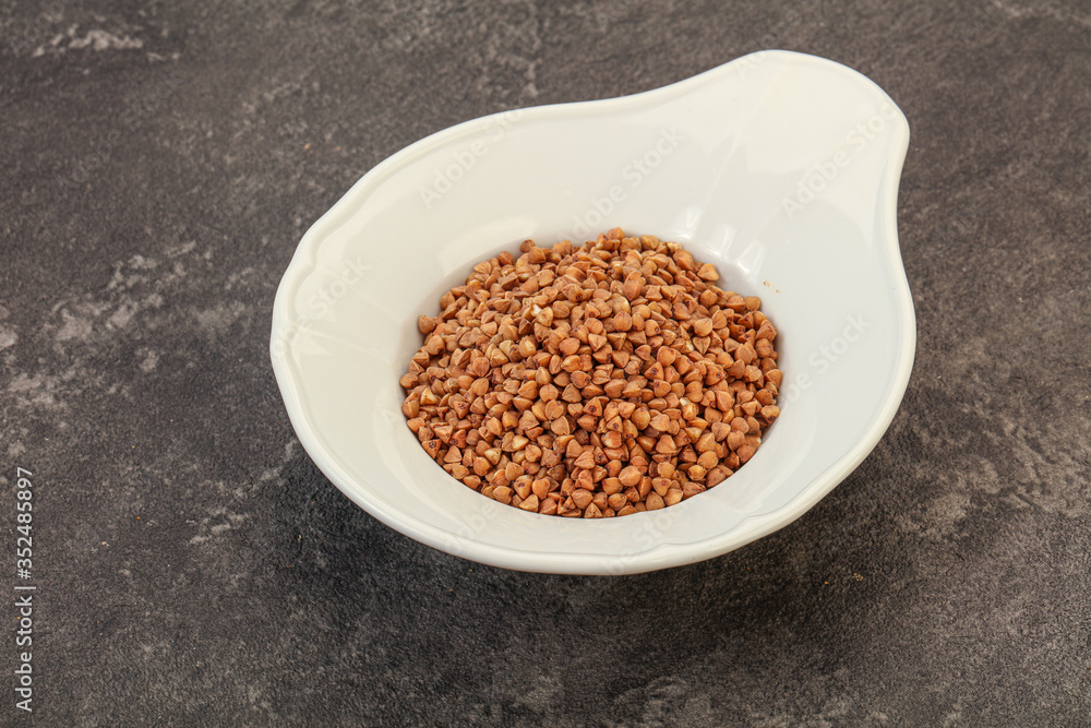 Raw buсkwheat cereal in the bowl Raw buсkwheat cereal in the bowl