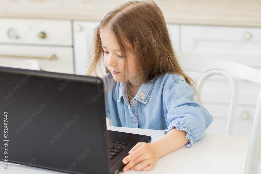 Pretty preschool girl studing at home with digital table laptop. Pretty preschool girl studing at home with digital table laptop.