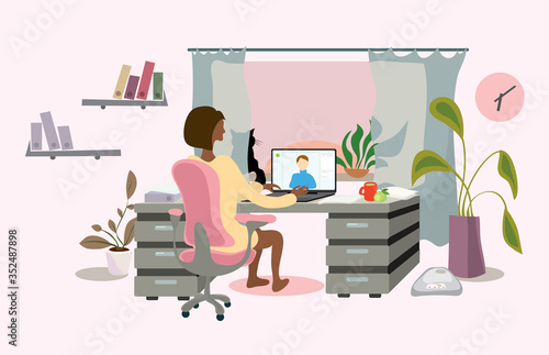 a business lady in a chair at the table is negotiating a video call from home. time for active remote work