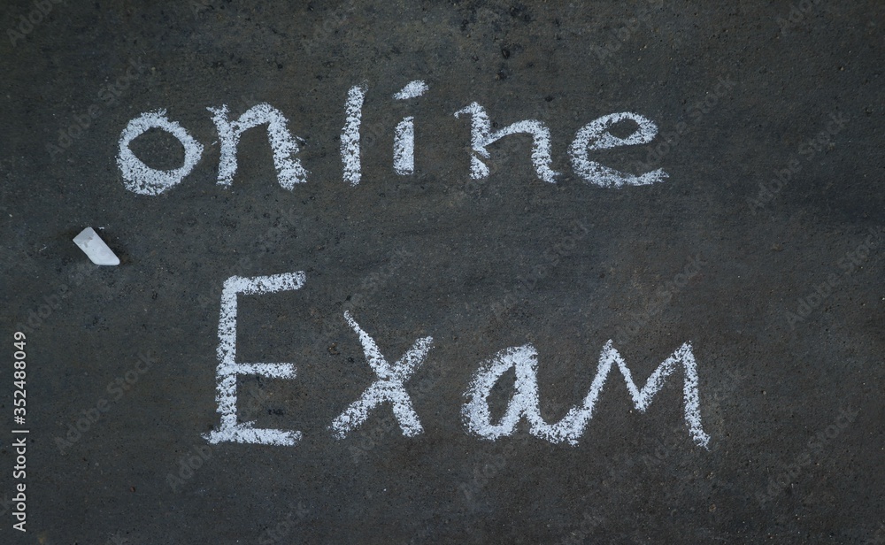 Fototapeta premium Online Exam Written with White Chalk on Black Surface