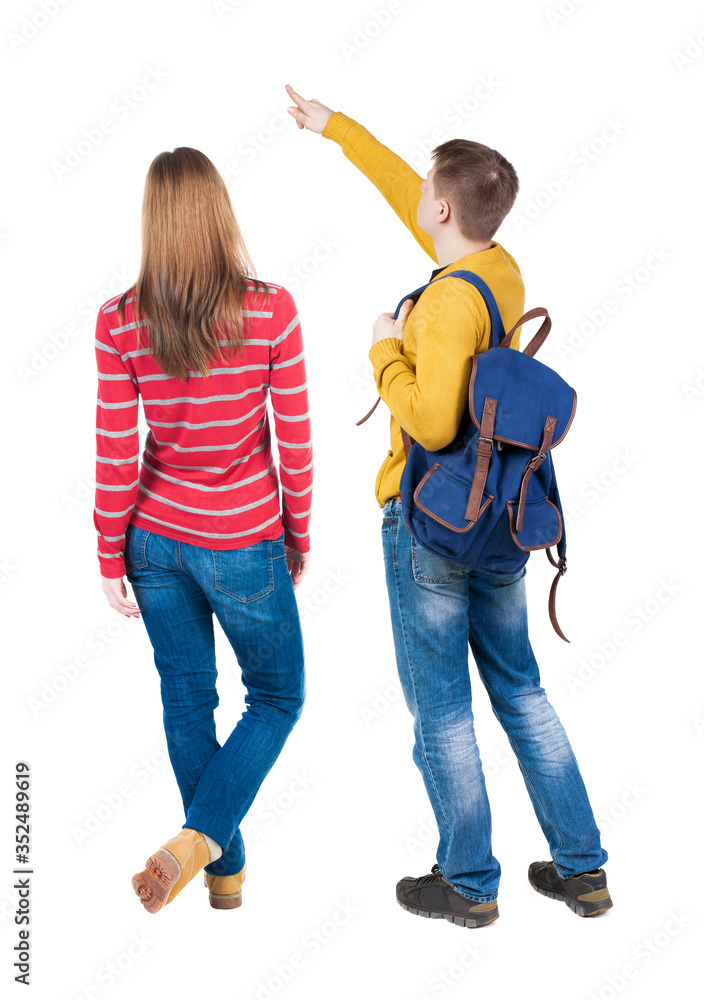 Fototapeta premium Back view of couple in sweater with mobile phone.