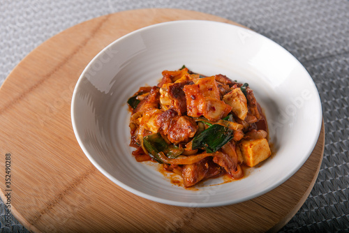 Homemade spicy pork belly cooked with kimchi, spring onions, onion and tofu. Marinated with red chilli paste called gojuchang.