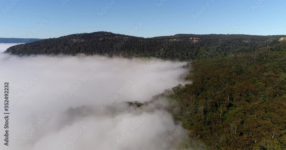 Thick clouds and fog over Kangaroo valley in soft warm morning light – aerial flying.
Thick clouds and fog over Kangaroo valley in soft warm morning light – aerial flying.