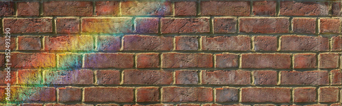 Inspirational Rainbow rustic brick wall message background banner - Wide natural coloured grunge brick wall with a flash of rainbow across left corner providing a background for messages 